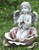 Angel kneeling in a rose garden statue. This gorgeous statues features a little angel kneeling in the center of a rose with her hands together in prayer. This statue can make a beautiful addition to your outdoor space.  Dimensions: 11"H x 9.25"W x 9"D. Resin and stone mix