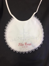 Beautiful Girl's Keepsake Cotton Christening Bib comes embroidered with cross and has a lace finished edge.  Can be embroidered at an additional cost. Script style embroidering is shown