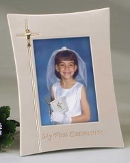 This 9" x 11" First Communion picture frame is beautiful and a great way to remember your boy's or girl's First Communion.  This pearlized ivory colored picture frame is adorned with a cross etched into the left side of the frame and a chalice placed in the middle of the cross and holds a 4 x 6" photograph. The words “My First Communion” are etched in gold colored writing at the bottom of the frame.

