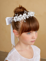 Girl wearing a floral headpiece.