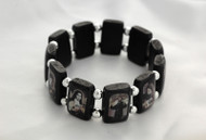 Popular Brazilian Wood Stretch Bracelet. Portrays black and white images of popular Saints and visions of Our Lady. 3/4" Black Wooden Rectangular Shape separated by Beads. 

 