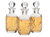 Chrismal Set of Lead Crystal Bottles with 10 ounce capacity each, Height: 7". Bottles are etched with OI, OS,  & SC. Note:  All glass may have irregularities. 