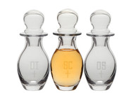 Crystal Chrismal Set - 4 ounce capacity, Height: 6 1/4". Bottles are etched with OI, OS, & SC. Note: All glass may have slight irregularities. 