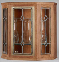 Ambry - Clear leaded beveled glass in door and two side panels. Made of Oak Plywood with light finish. Adjustable glass shelf inside. Size: 25"H x 24-1/2"W and 10-1/2"D. Lighted interior