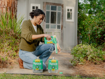 Man spraying Spruce 64oz Power Wand in backyeard.