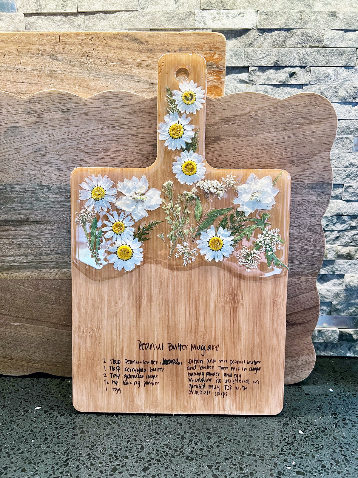Pressed flower cutting board with handwritten recipe made with Ikonart stencil and Torch Paste