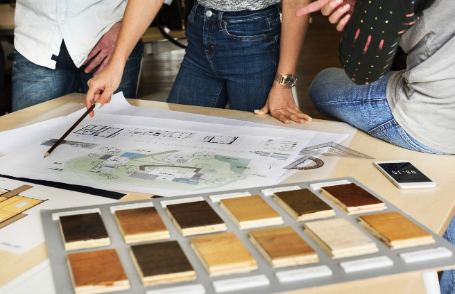 People reviewing architectural plans and material samples