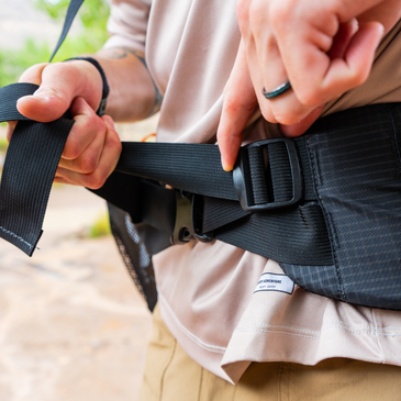 a man adjusts the tightness of the hipbelt 