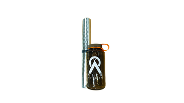 a silver fire mat rolled up next to a Nalgene water bottle for size comparison