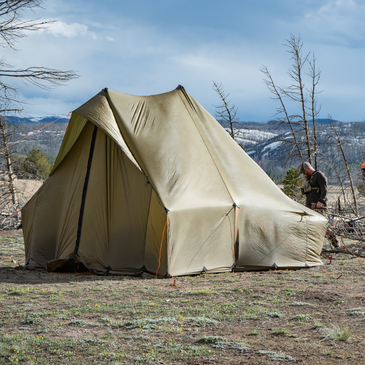 Forest basecamp with Courthouse shelter, 11'4" by 9'6" rectangular footprint, 6-inch sod skirt sealing out drafts