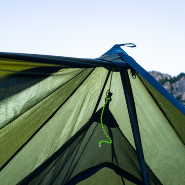 close up on the inside of a Brightwater tent, showing the nest connected to the center cone with yellow cordage
