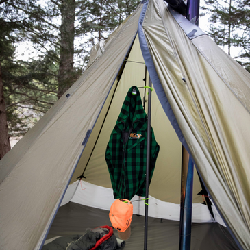 redcliff tent with doors open, showing a jacket and a hat hanging from a pole drying hook
