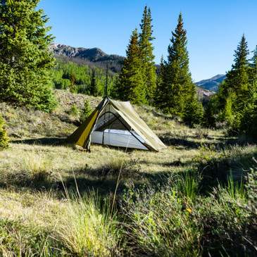 Two-person Guardian Nest inside trekking pole tent, nest zipper closed, tent doors tied open for ventilation, DWR fabric top visible for condensation protection