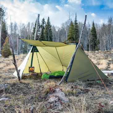 Guardian 2.0 close up with awning open showing fire burning inside tent stove