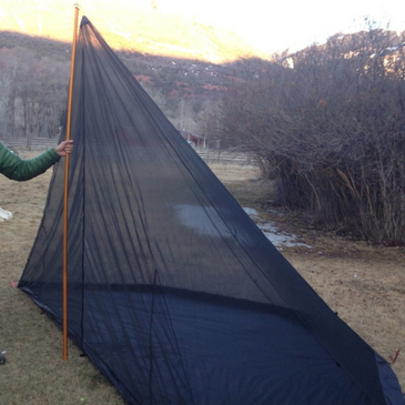 Seek Outside 8-person nest set up alone in fair weather, 15-foot length and 7-foot-8-inch peak height with mesh protection on all sides