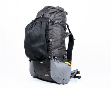 mesh talon stuffed with gear attached to the front of a Seek Outside backpack