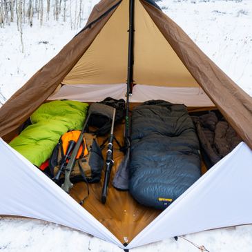 hunting camp with sleeping gear for three, rifles and hunting packs protected from the snow inside removable floor option