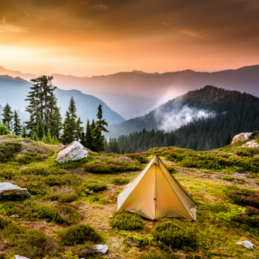 Backcountry camp with Seek Outside Cimarron shelter against dramatic peak backdrop, stove jack visible