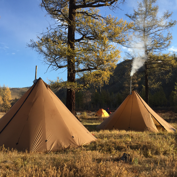 hunting basecamp with a 16 person tent set up next to a 12 person tent, showing the 16 persons' 10' 6" height 