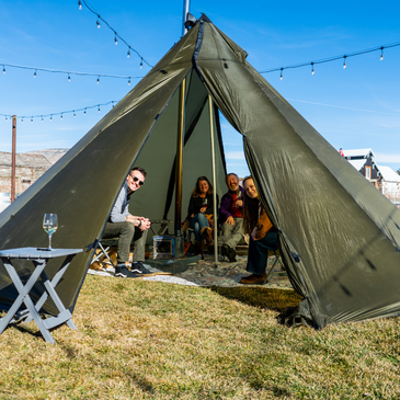 large group gathers inside 16 person tipi, chairs and small tables spread through the 345 square foot interior 