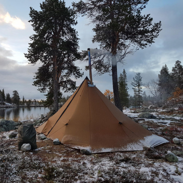 Hunting camp basecamp with Seek Outside Redcliff 6-person hot tent, stove setup for late-season warmth and gear drying