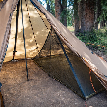 Two-person nest inside Redcliff tent with sleeping gear for two adults and mesh sides fully zipped closed for bug protection