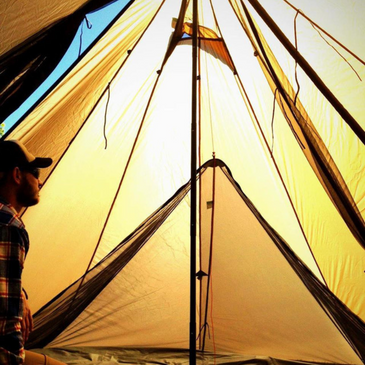 Two-person nest inside Redcliff tent with sleeping gear for two adults and mesh sides fully zipped closed for bug protection