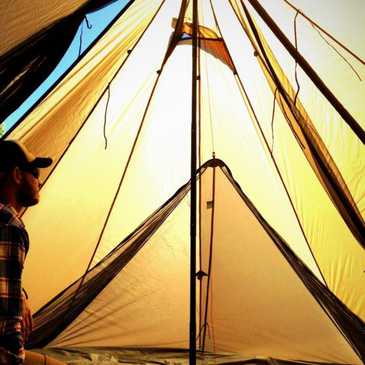 Two-person nest inside Redcliff tent with sleeping gear for two adults and mesh sides fully zipped closed for bug protection