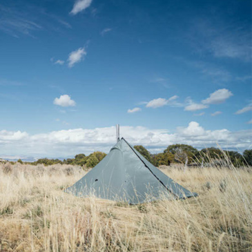 cimarron light tent with stove pipe coming through heat resistant stove jack