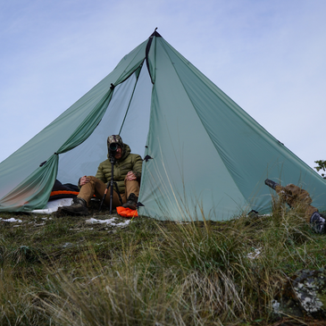 hunter uses spotting scope inside redcliff light tent with ample headroom