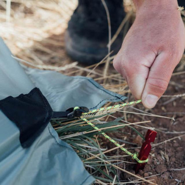 person adjusts the tension on  Line Loc Stake Out Point
