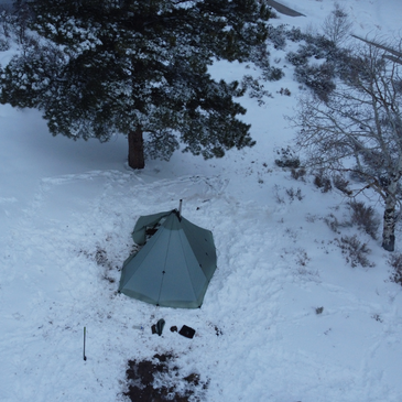 arial shot of a Redcliff light tent with liner and stove in chilly winter camp