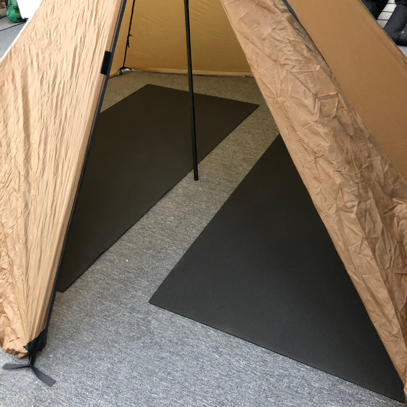 two matty ground mats on the ground inside a brown tent