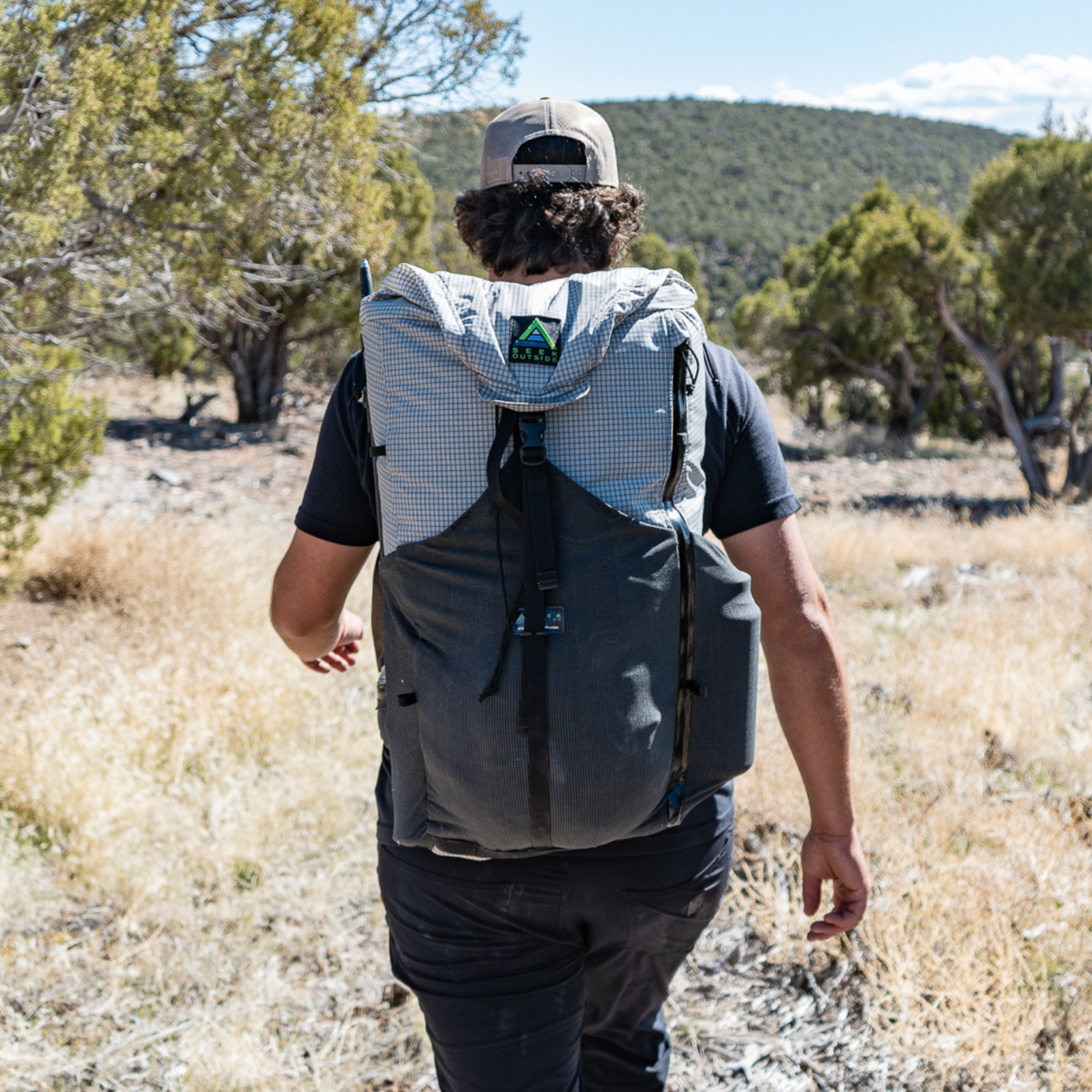Hiker traverses rocky desert trail, Silverton's 2-way hip belt cinched for a secure fit