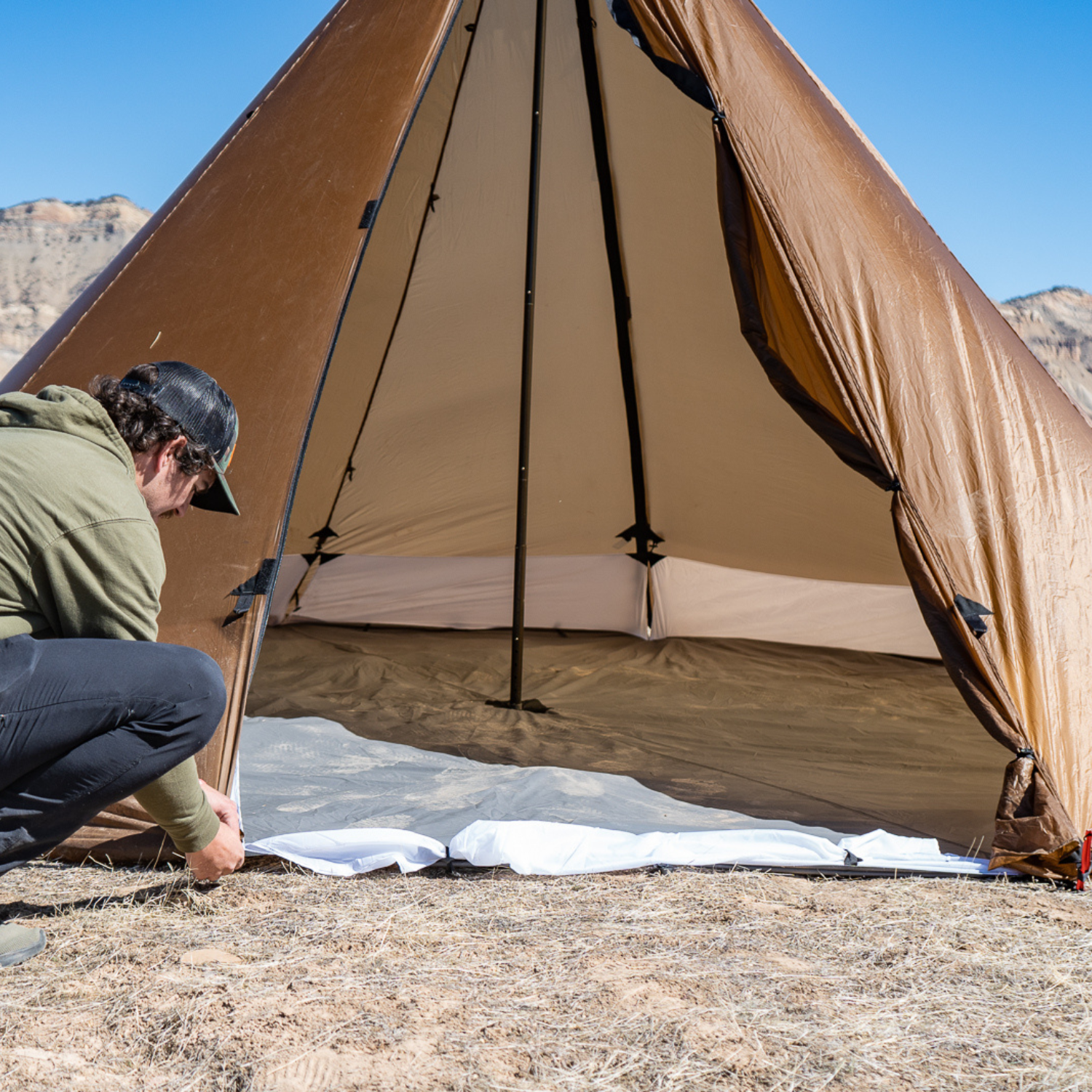 backcountry hunter uses stake loops to secure 8 person floor liner system to the tent stakes