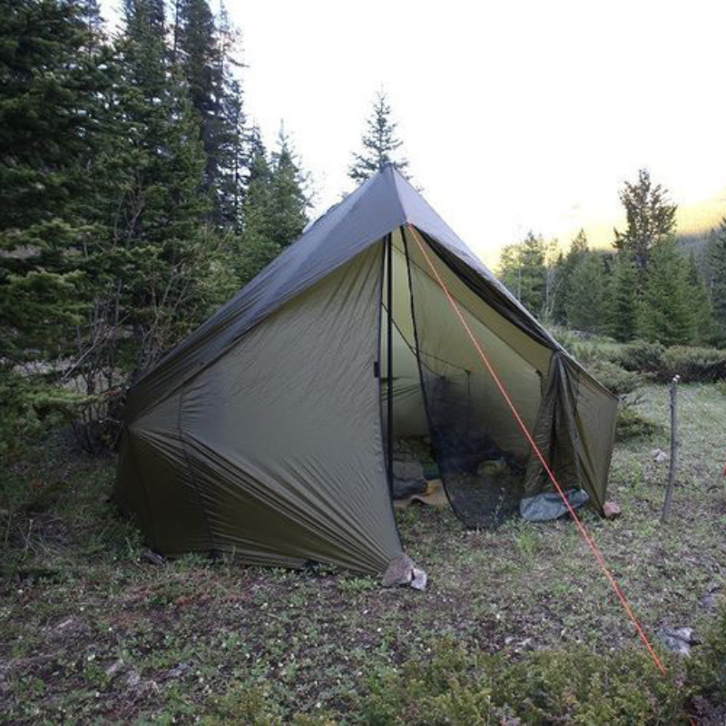 A Courthouse tent set up in a forest, surrounded by trees