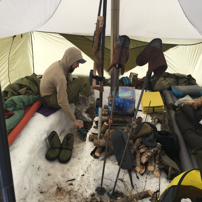 Inside Courthouse floorless tent showing snow on ground inside shelter, 8-foot center height, 126 square feet, 31-inch side walls with snow piled around sod skirt