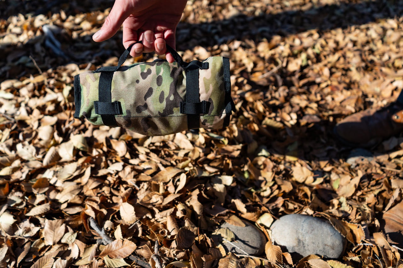a man holds a rolled up flat roll, rolled up 