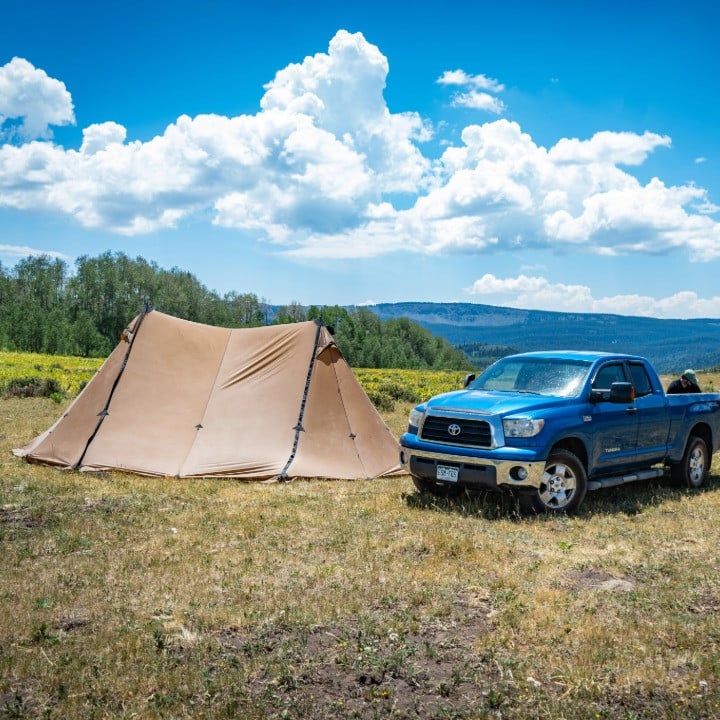 Bookcliff 8p Xl next to a full size truck a toyota tundra, the bookcliff stands above the truck showing its height