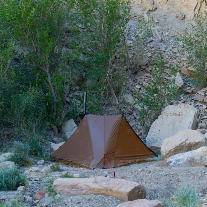Silex tent with stove jack open and stove pipe extending through peak, 4-season capability with optional stove