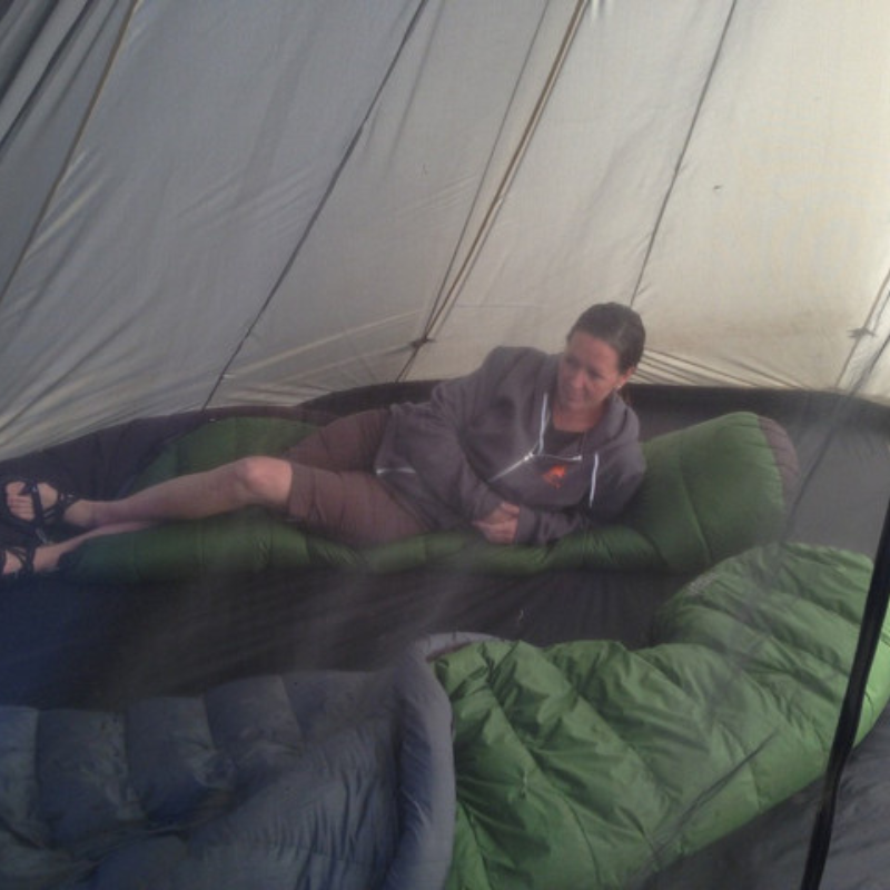 8 Person Half Nest inside tipi with two sleeping bags side-by-side, family camping setup