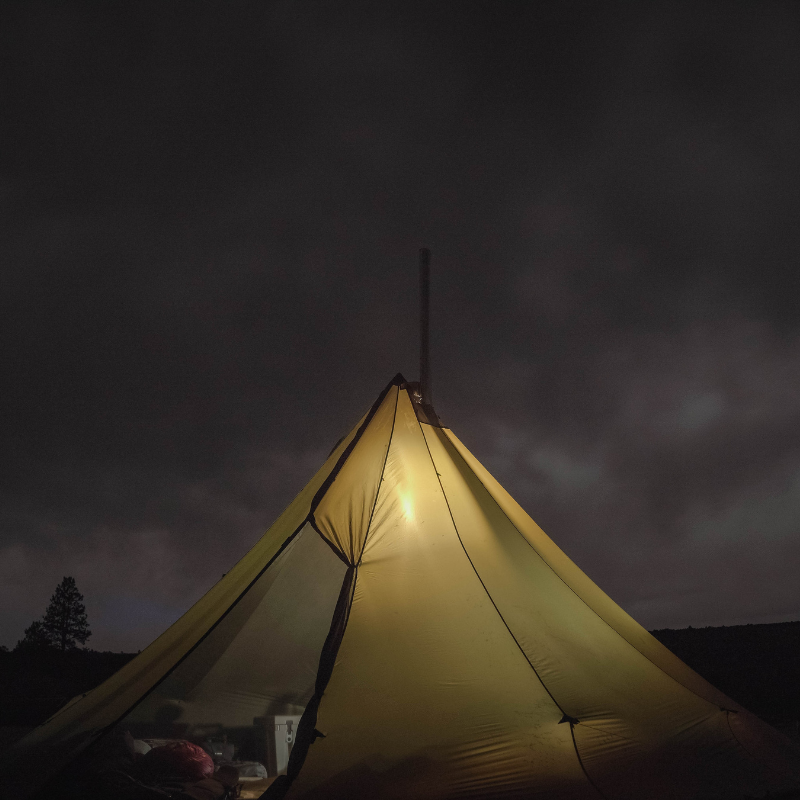 12 person tipi at night, tent illuminated from the inside with a glowing light