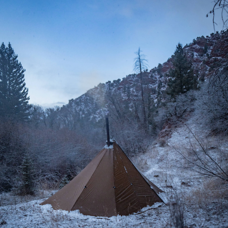 Seek Outside Redcliff 4-season hot tent pitched at hunting camp, showing single/double door access and stove jack