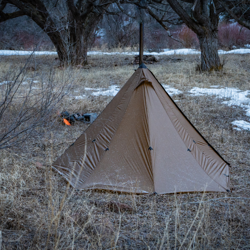 Seek Outside Redcliff 4-season hot tent pitched at hunting camp, showing single/double door access and stove jack