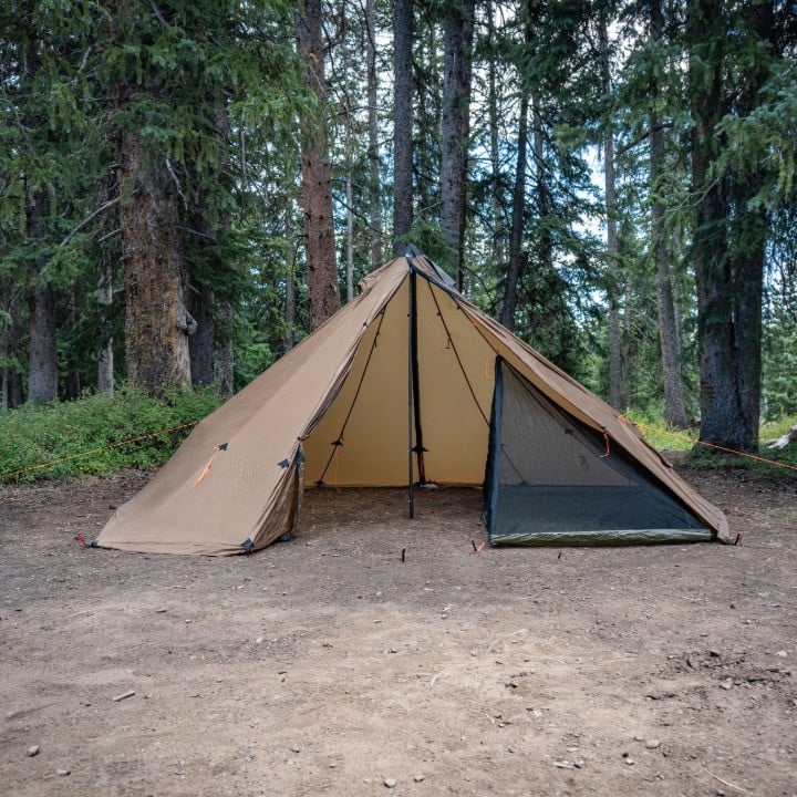 redcliff tent with Half Nest set up on one half, leaving the other half open for gear, stove, and muddy boots