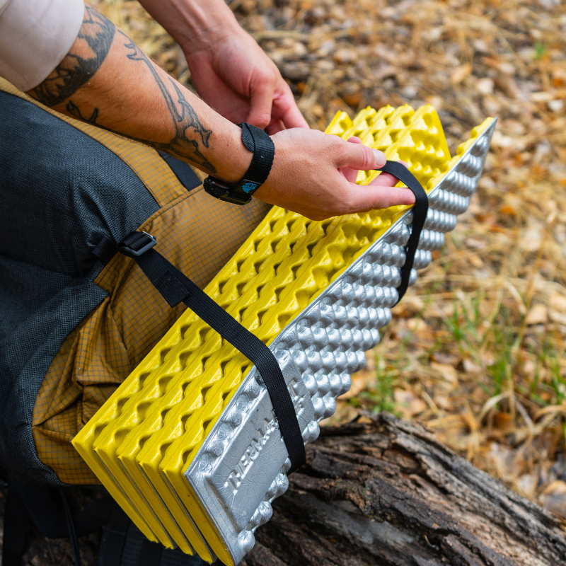 person adjusts the tension on gatekeeper strap to keep added load tight