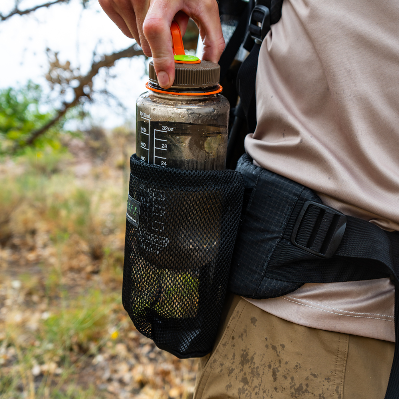 bottle holster attached to Seek Outside hip belt with MOLLE system