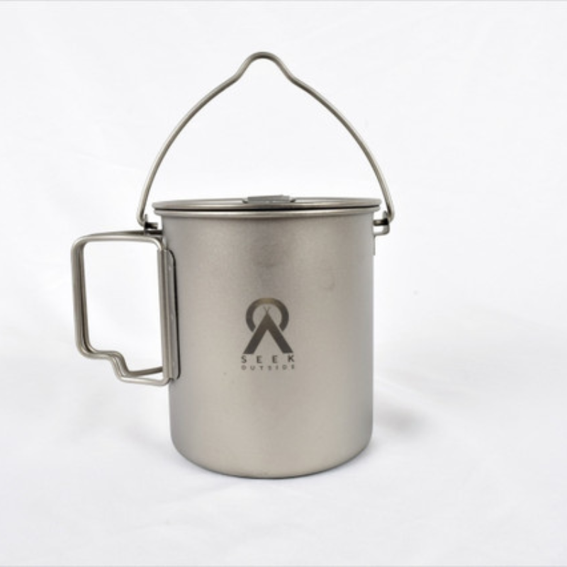 Seek Outside titanium mug with bail handle, regular handle, and lid on white background