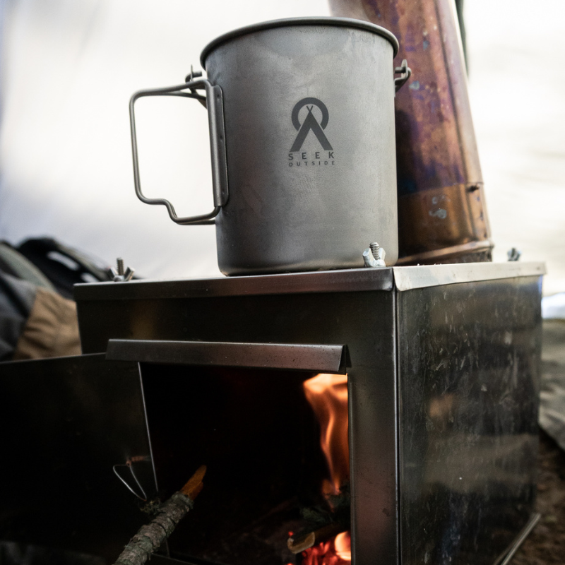 Boiling water in titanium mug with bail handle on titanium wood stove