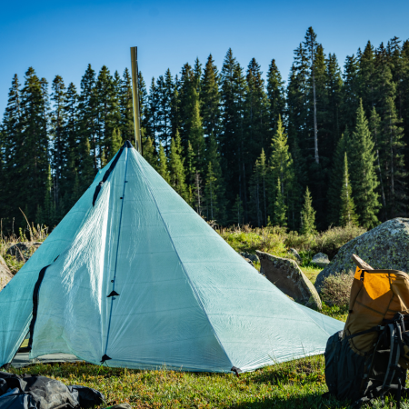Dyneema Redcliff with stove pipe coming through stove jack in camp